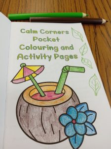 photograph of coloured in page with shapes added